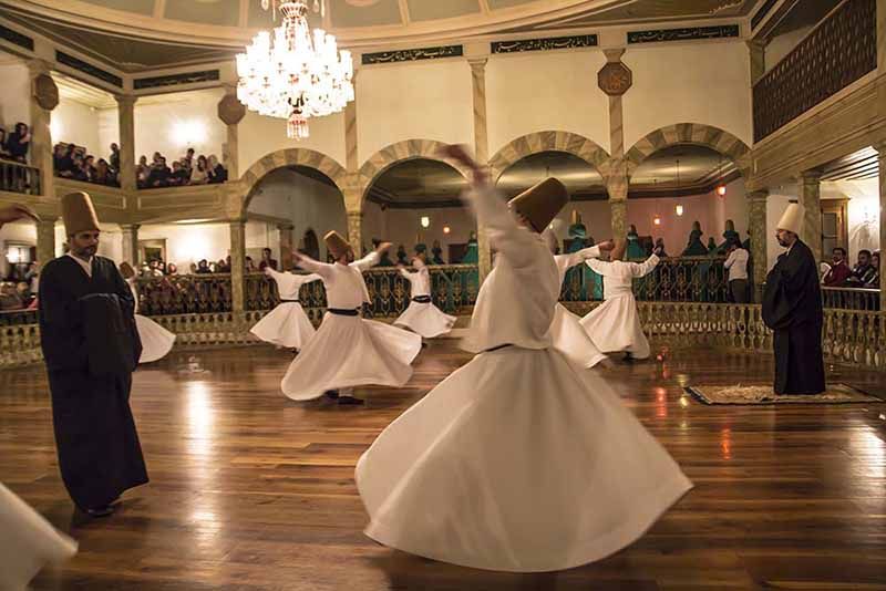 Sufi whirling dervish (Semazen) dances at Yenikapi Mevlevihane on October 5, 2016 in Istanbul. Semazen conveys God's spiritual gift to those are witnessing the ritual.